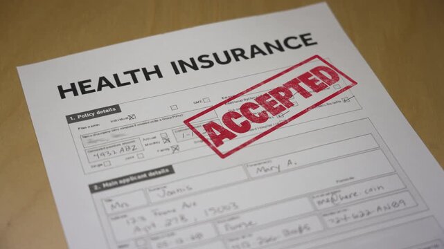 Health insurance application form stamped with a bold red &ldquo;ACCEPTED&rdquo; mark, representing approval, coverage, and financial protection. Fictional data on form. 14940  	