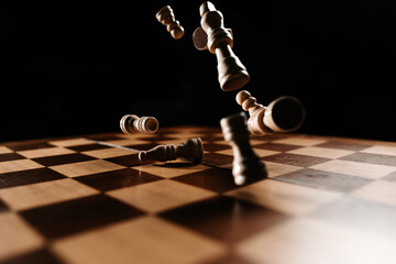 Chess pieces flying above board, chaos after a decisive move