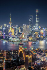 Fototapeta premium Shanghai Skyline at Dusk with Oriental Pearl Tower and Huangpu River Reflection