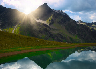 View on a lake and mountains above Defereggental valley on a summer day
