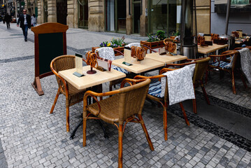 View of old street with tables of restaurant in Old Town of Prague, Czech Republic. Cozy cityscape of Prague