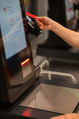 Obraz premium Woman paying with credit card at self-checkout. 