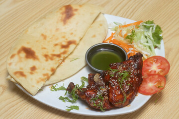 Authentic tandoori chicken with freshly baked naan and flavorful green chutney. Perfect for menus, blogs, and culinary projects.