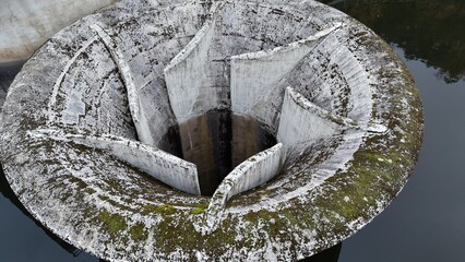 Concrete drainage well with moss growth. Perfect for construction backgrounds infrastructure textures engineering diagrams urban planning