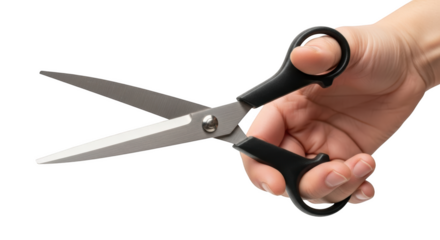 Hand holding open black handled scissors with silver blades isolated on a transparent background cutting
