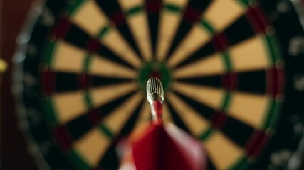 Immersive point of view shot of a red dart flying through the air and hitting the bullseye in the center of a dartboard, representing the concept of precision, success, and achieving goals - Powered by Adobe