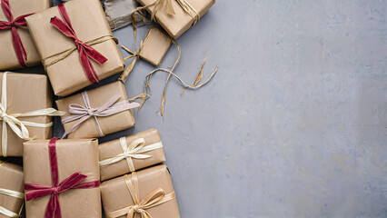 The image showcases a collection of elegantly wrapped brown gift boxes, adorned with colorful ribbons, arranged neatly on a light gray surface, creating a warm and inviting atmosphere perfect for any 