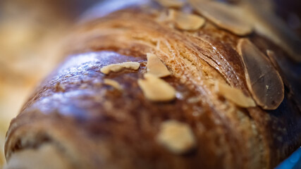 A sweet bun covered with nuts on top.