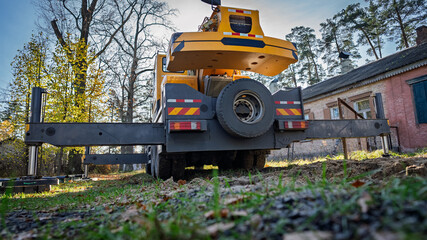 The truck crane is in the process of being prepared for work.