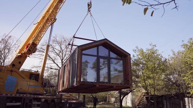 The process of delivering a modular house to the site.