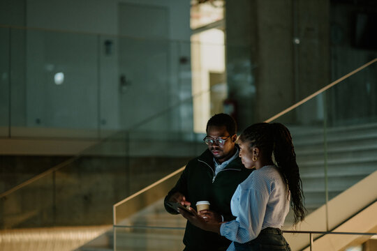 Business colleagues collaborating on tablet in modern office