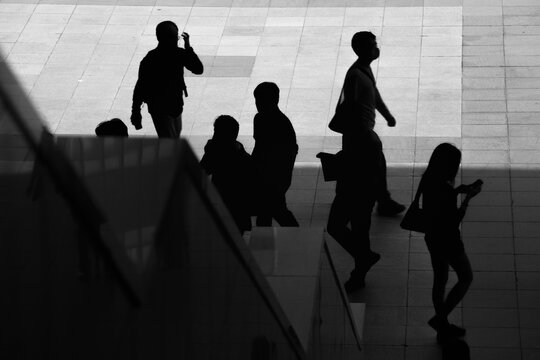 Silhouettes of People Walking in Urban City Environment
