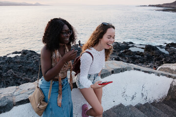 Two diverse women friends laughing on Canary Islands holiday