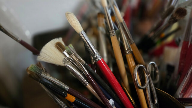 Creative atmosphere in an artist's studio with paintbrushes for art projects. Close-up
