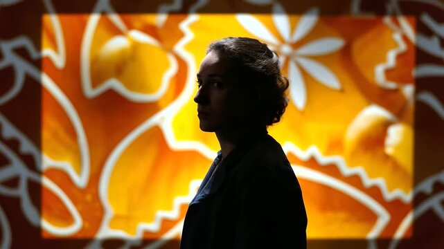 Partial silhouette of artist near crystal clear screen with seamless gingerbread and orange pattern display, with copy space