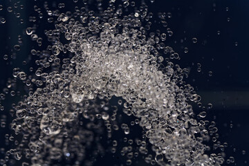 Ice Crystals and Bubbles in Icy Dark Liquid Close-Up