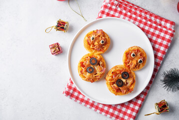 Pizza mini with salami in the form of snowman for Christmas holidays on a white background