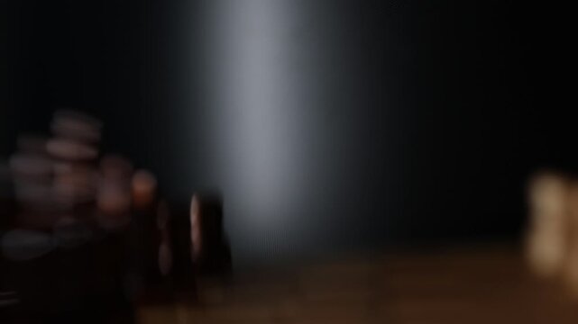 Dynamic video sequence of chess pieces positioned on a slowly rotating chessboard, symbolizing the intellectual confrontation between black and white opposing forces in strategic gameplay.