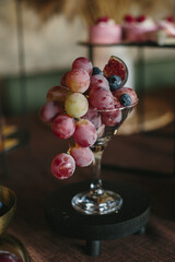 Grapes, figs, and blueberries in elegant glass for buffet