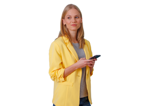 Young woman in yellow blazer looking away, smiling, holding smartphone, analyzing new ideas