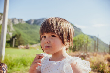 A portrait of a beautiful young girl in a white dress