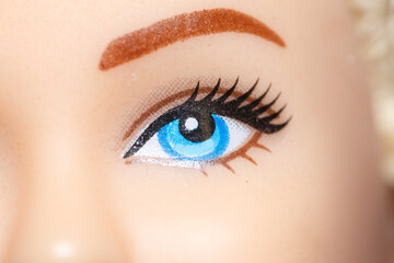Part of the face with an eye of a plastic children's doll.