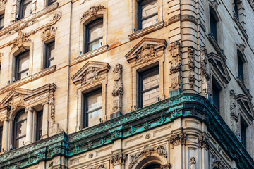 Montreal, Canada - August 11, 2025: Historic building facade with ornate stonework and green copper details in downtown Montreal, Quebec