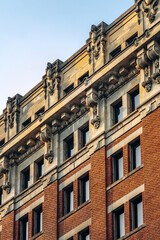 Detailed view of historic architecture with ornate stonework and red brick facade in downtown Montreal, Quebec
