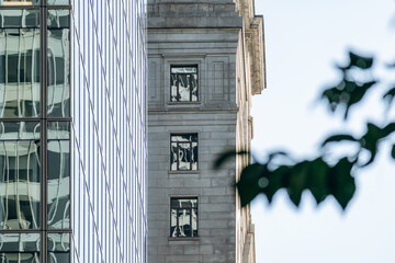Architectural details with glass reflections and stone facade, modern and historic downtown Ville-Marie buildings, Montreal, Canada