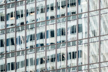 Architectural details with glass reflections and stone facade, modern and historic downtown Ville-Marie buildings, Montreal, Canada