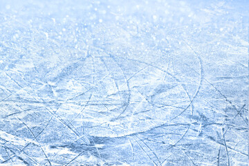 Winter background. Texture blue ice surface with scratches of skates