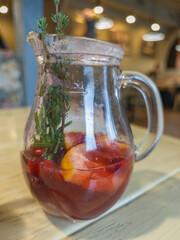 Pitcher of fruit punch is sitting on a table