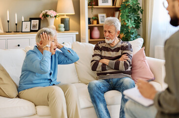 Mature couple consultation session with health therapiest or doctor at home or in doctor's office, or an insurance real estate agent