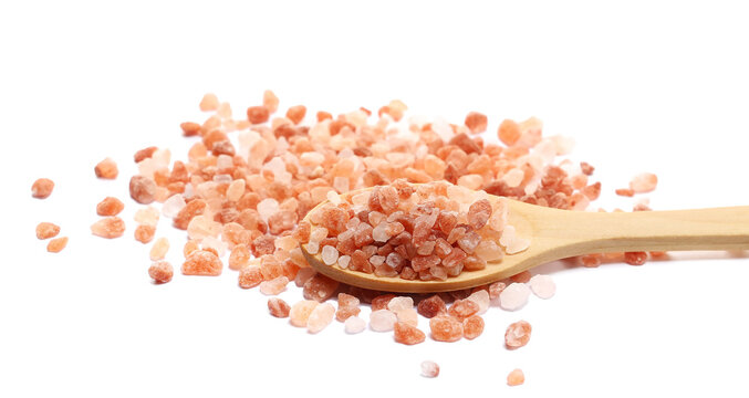 Himalayan salt grains pile in wooden spoon isolated on white background, side view - Powered by Adobe
