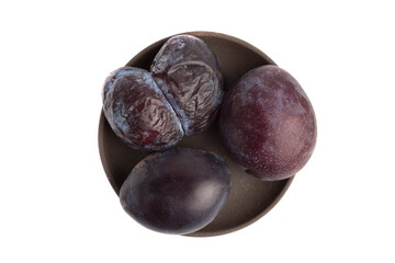 a plate with old plums, top view