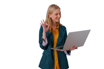 Businesswoman giving ok sign while using laptop for remote work or online communication, showing success and approval