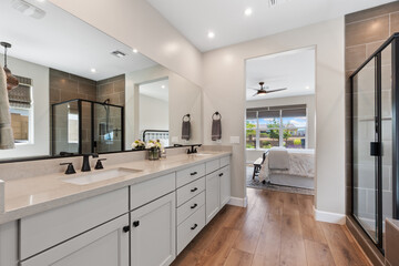 A spacious bathroom featuring two sinks and a large mirror above