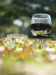 Drip coffee on the autumn morning grass