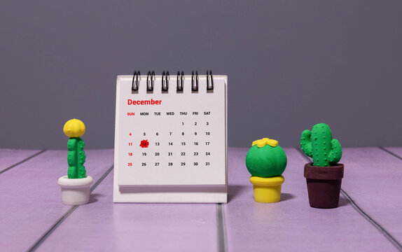 Wooden calendar December 12 on a white background close up.