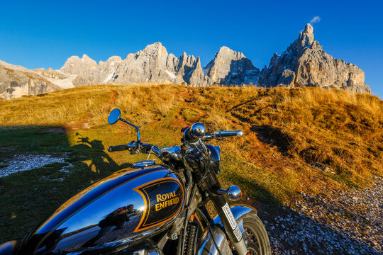 Royal Enfield motorcycle parked in front of Pale di San Martino, Dolomites, Italy, Europe