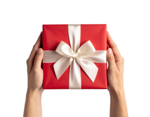 Hands carefully hold a beautifully wrapped red gift with a creamy white bow, perfect for seasonal wishes and gratitude