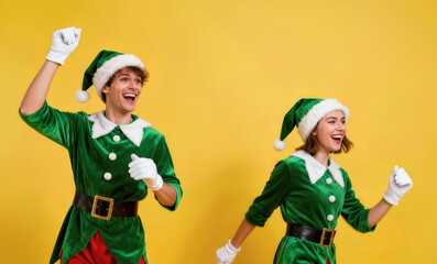 Joyful holiday celebration with two people dressed as Christmas elves against a bright yellow background, showcasing excitement and festive spirit during winter festivities