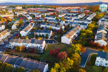 Colorful autumn neighborhood in Leesburg with rows of houses at sunrise