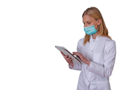 Medical professional wearing face mask and white coat, using digital tablet for healthcare data, transparent background