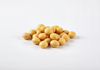 Isolated pile of soybean seeds on a plain white surface showing their natural color and texture, showcasing nutritious legumes.