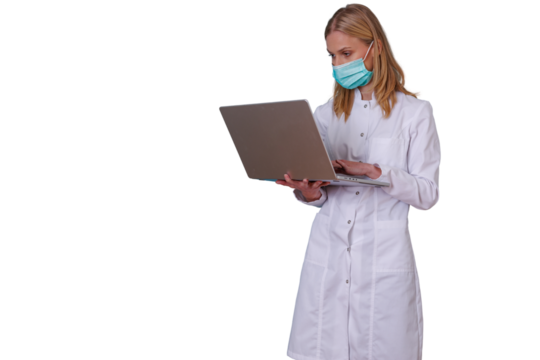 Female doctor in lab coat using a laptop for medical research and telehealth consultation, working with healthcare technology - Powered by Adobe