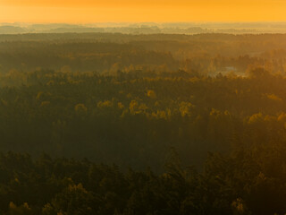 Aerial capture of a colourful autumn landscape in the forest during sunset