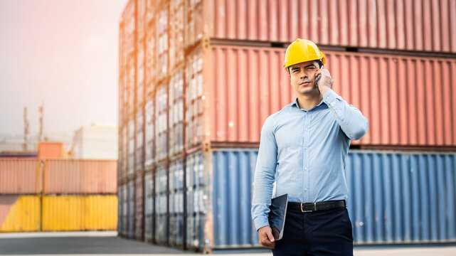 Worker use smartphone and ipad about business working at the port for transfer products.