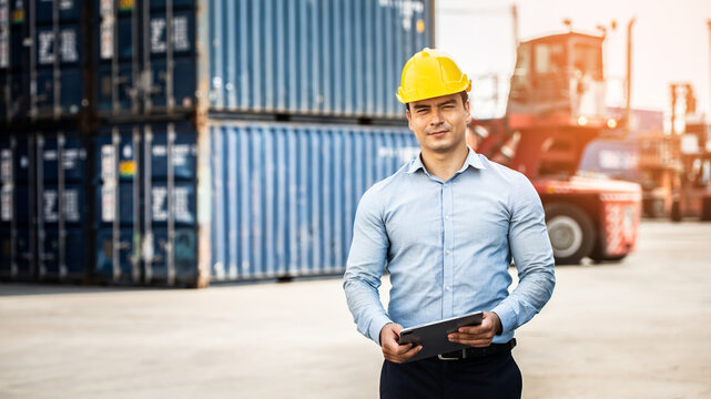 Worker use smartphone and ipad about business working at the port for transfer products.