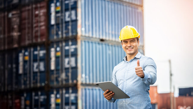 Worker use smartphone and ipad about business working at the port for transfer products.
